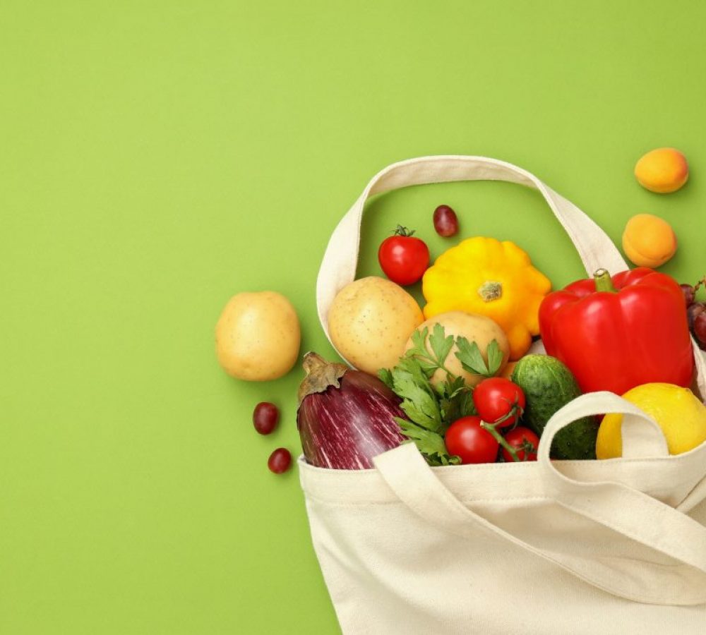 cotton-bag-with-vegetables-and-fruits-on-green-background.jpg